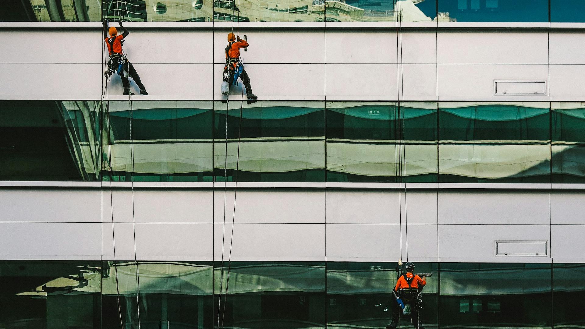 man cleaning white building